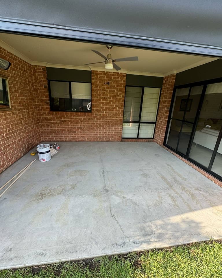 Worn concrete before charcoal resurfacing