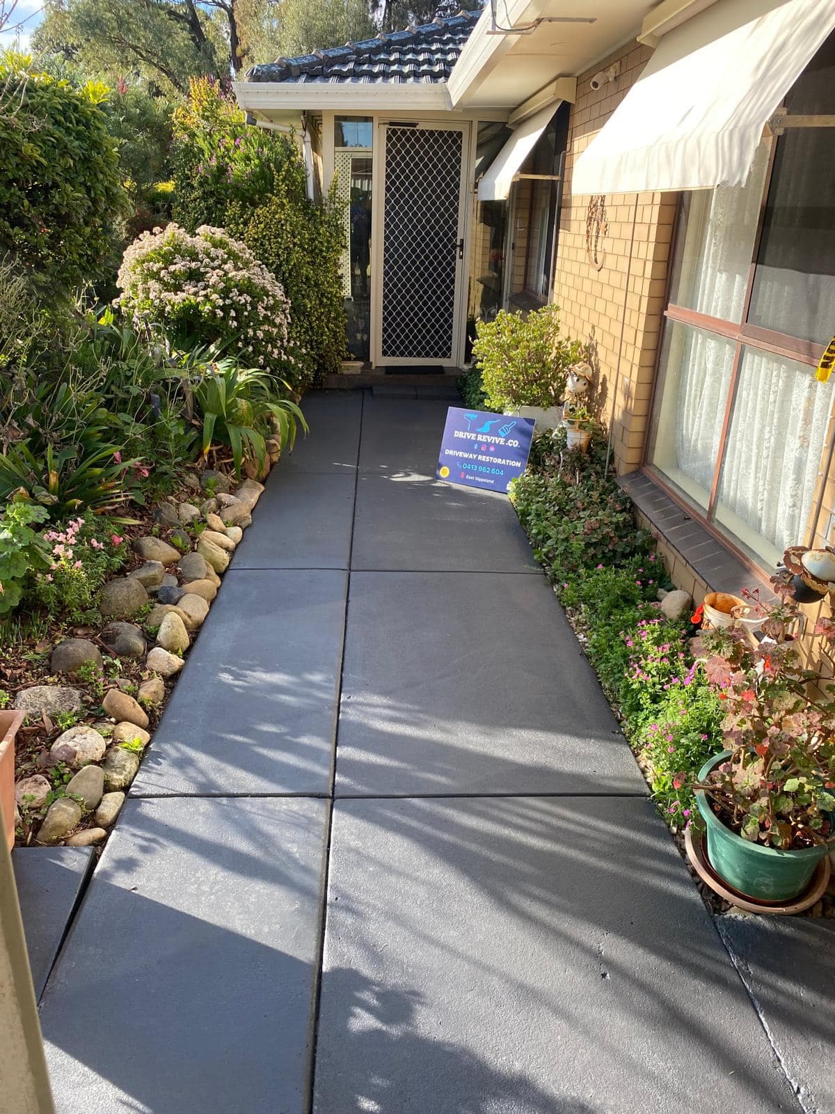 Charcoal colored decorative concrete path after professional resurfacing in Sale