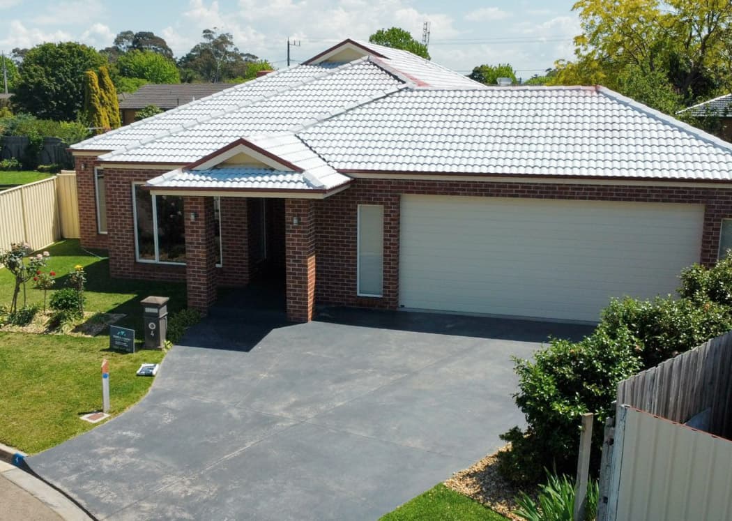 Damaged concrete driveway before monument finish restoration
